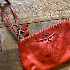 Like new Coach wristlet in red / orange